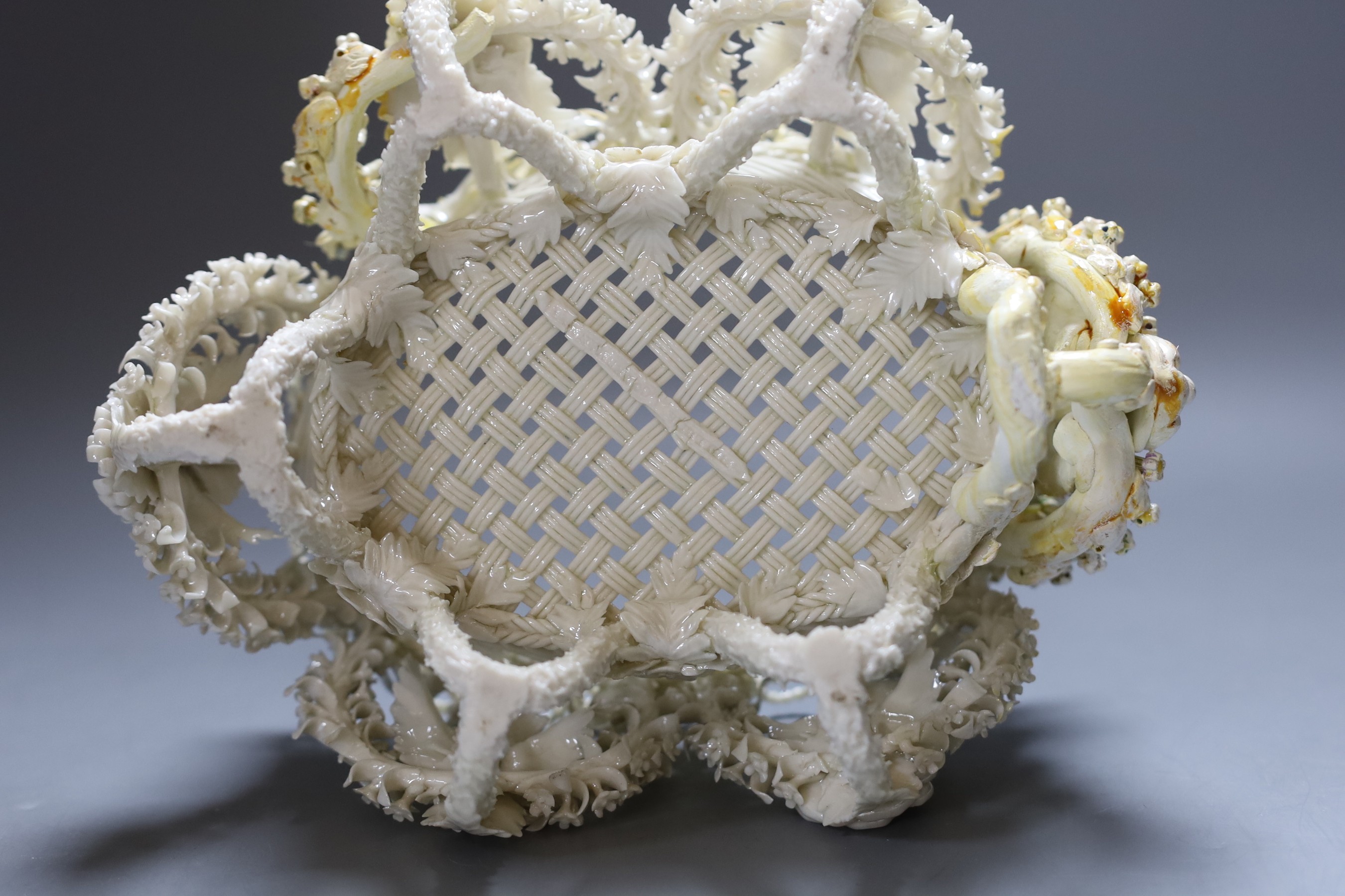 A Belleek floral encrusted basket (restored), 24cm